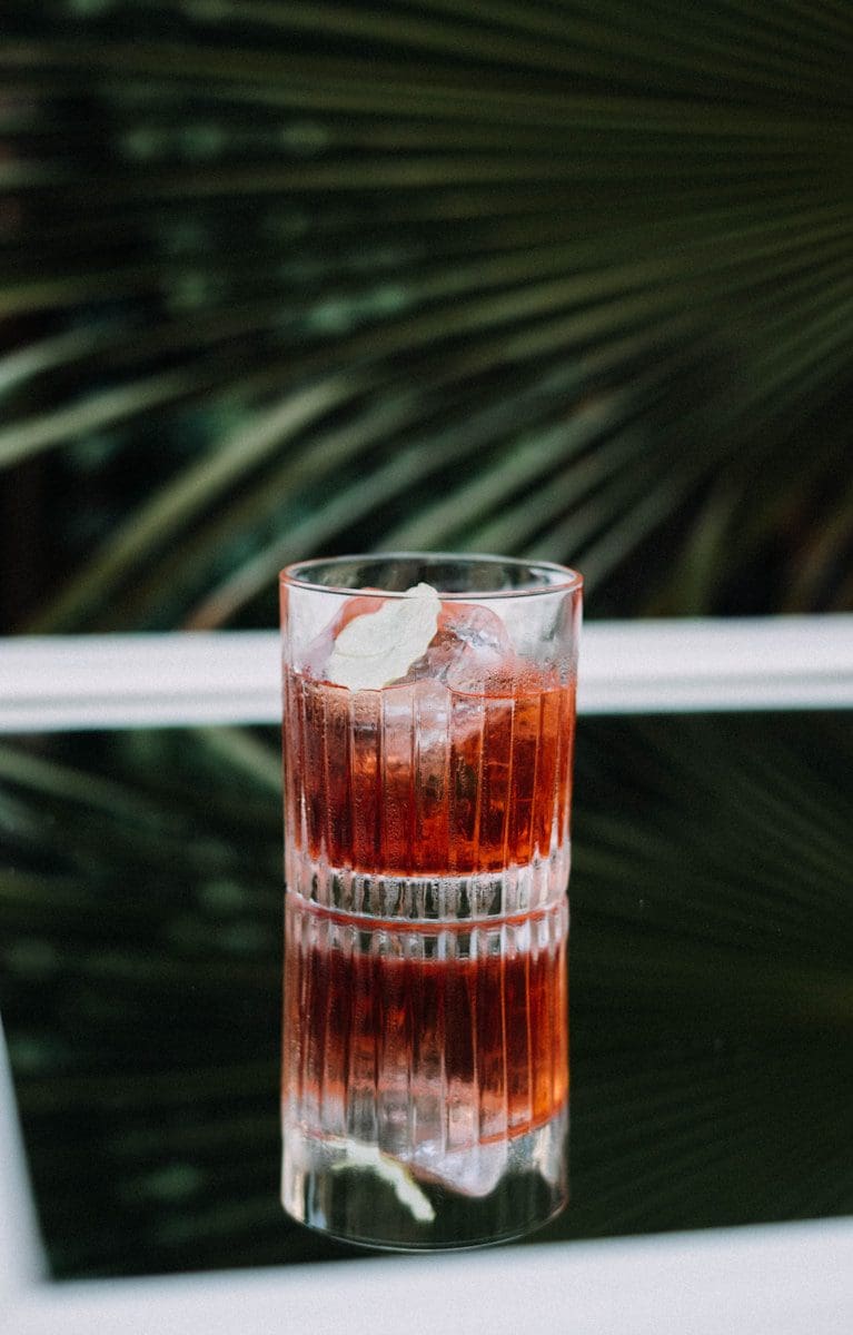 clear glass cup with brown liquid